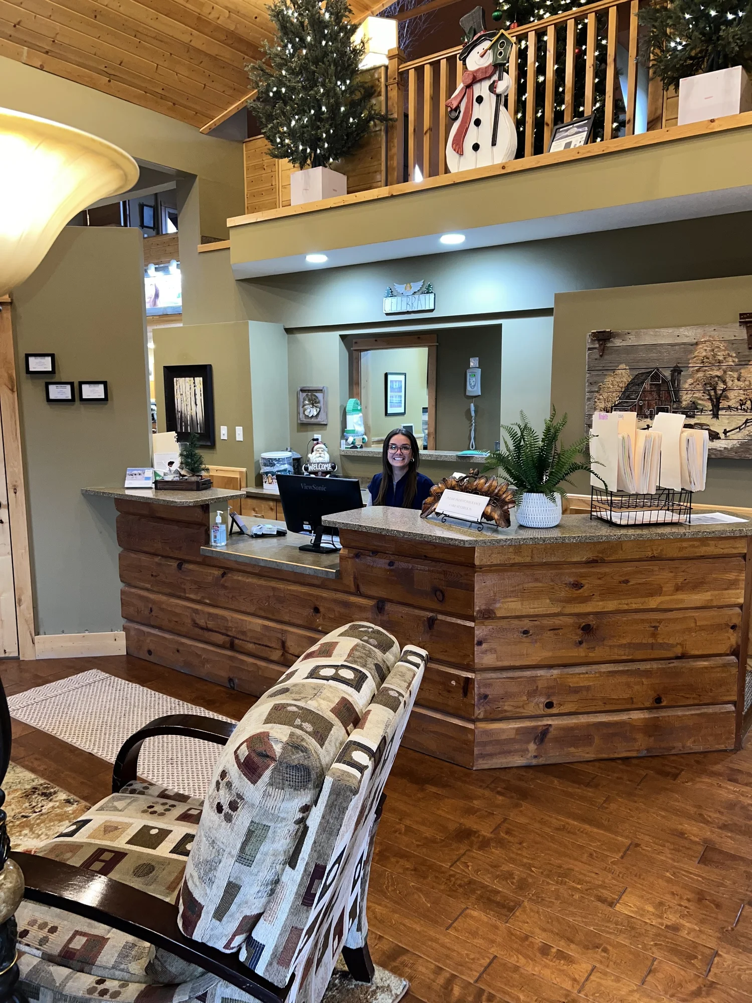 The warm, wood-paneled front desk and waiting area at Health Sense Dental in Shorewood, MN