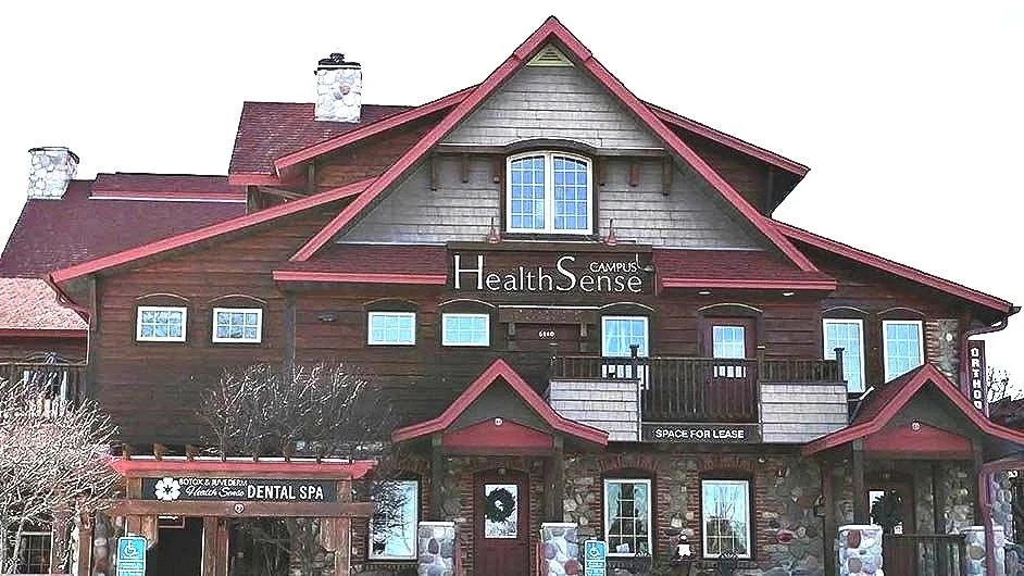 Exterior of the Health Sense Dental log-cabin building in Shorewood, MN
